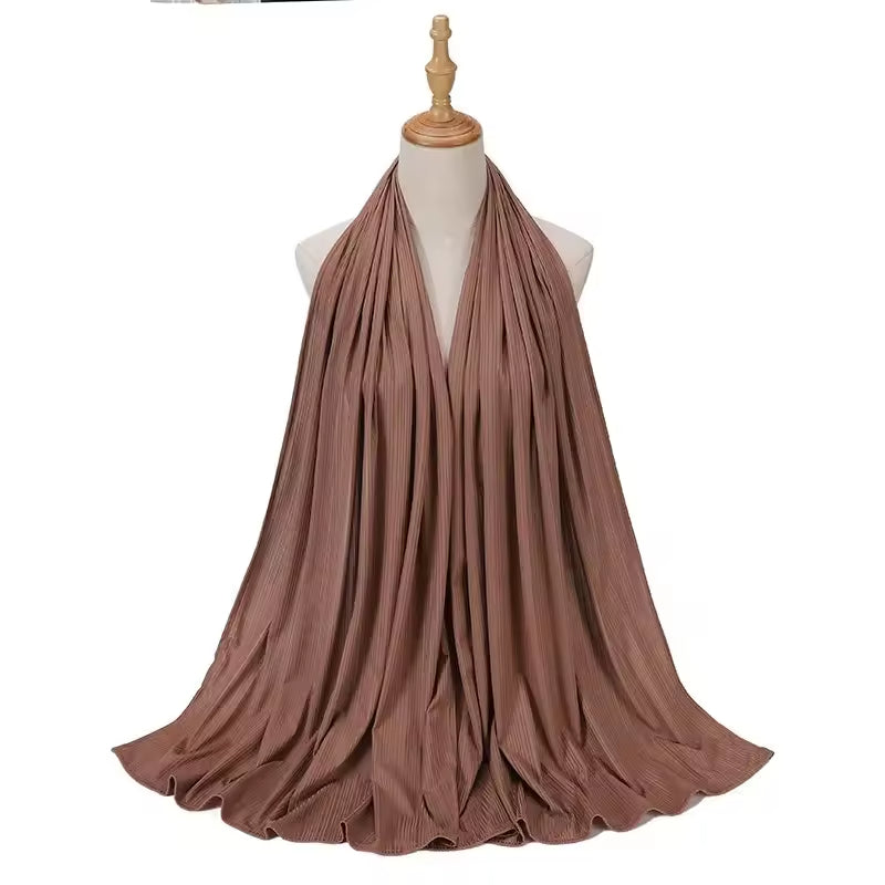 Brown scarf draped over a mannequin on a white background