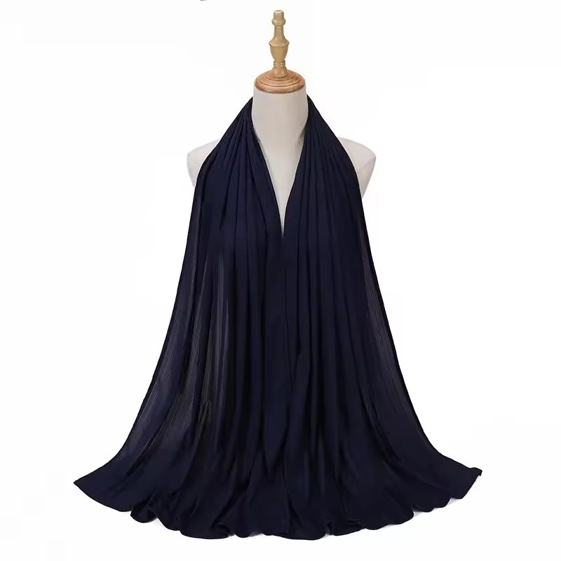 Navy blue scarf draped over a mannequin on a white background