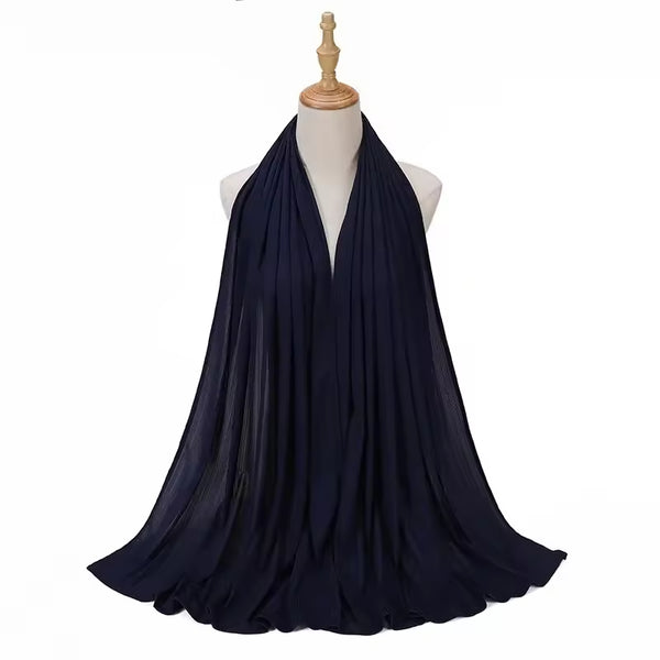 Navy blue scarf draped over a mannequin on a white background